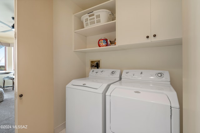 clothes washing area with separate washer and dryer, carpet floors, and cabinets