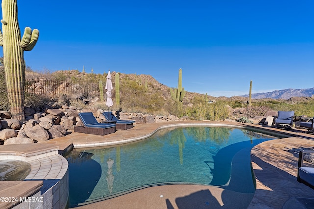 view of swimming pool featuring a mountain view and a patio