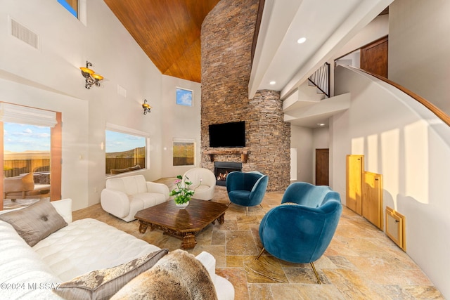 living room featuring a fireplace and a towering ceiling