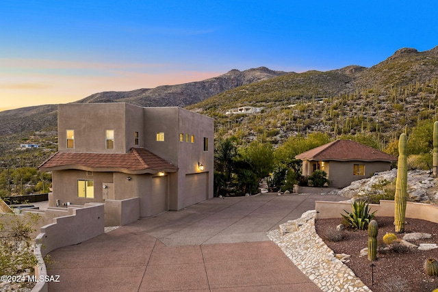 view of front facade featuring a mountain view and a garage