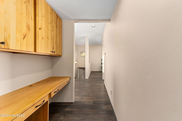 corridor with dark hardwood / wood-style flooring