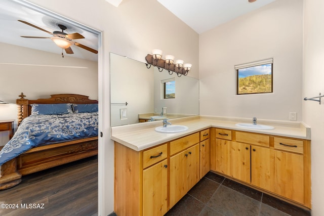 bathroom featuring hardwood / wood-style floors, ceiling fan, vanity, and vaulted ceiling