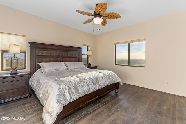 bedroom with dark hardwood / wood-style floors, ceiling fan, and multiple windows