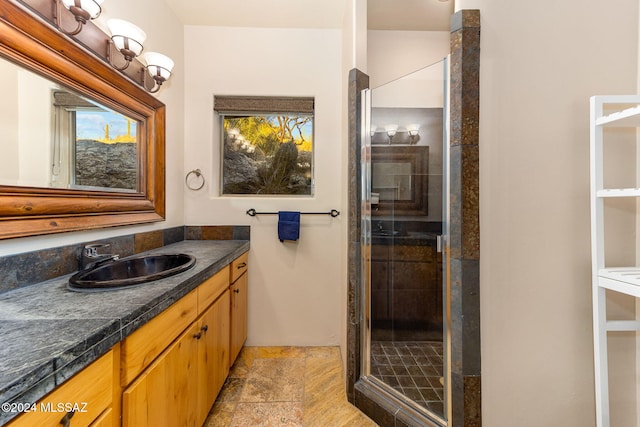 bathroom with vanity and a shower with shower door