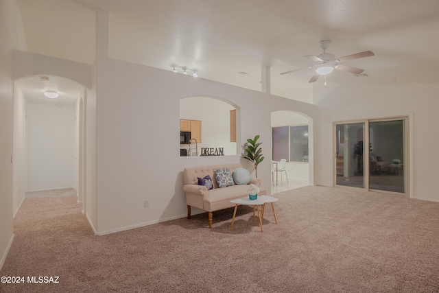 living room with light colored carpet, ceiling fan, and lofted ceiling