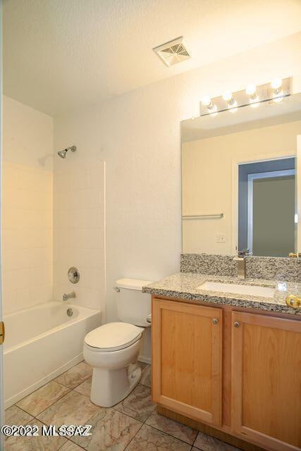 full bathroom featuring vanity, toilet, and tiled shower / bath