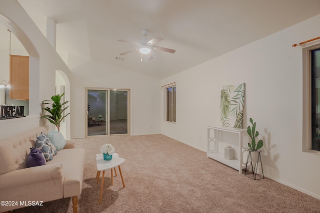 carpeted living room featuring ceiling fan and lofted ceiling