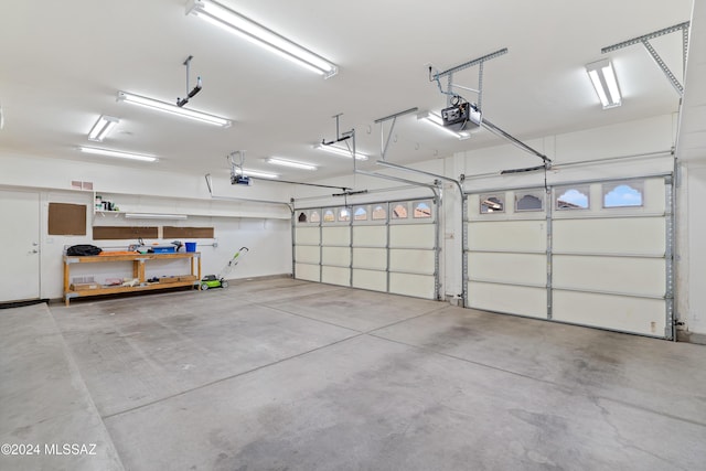 garage featuring a garage door opener and visible vents