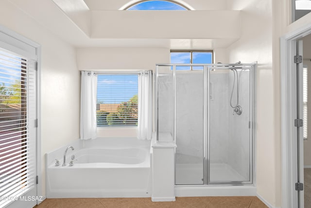 bathroom featuring tile patterned floors, a shower stall, and a garden tub