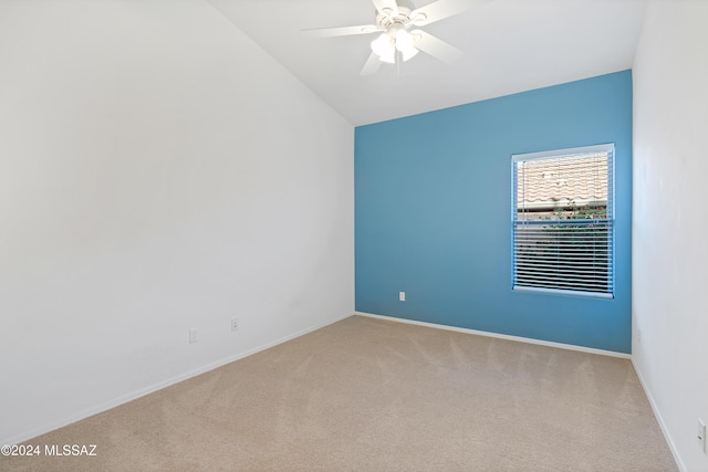 unfurnished room featuring baseboards, carpet, lofted ceiling, and a ceiling fan