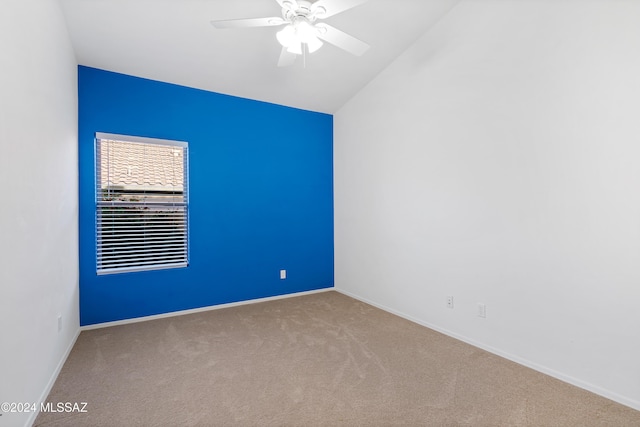 carpeted empty room featuring lofted ceiling, baseboards, and ceiling fan