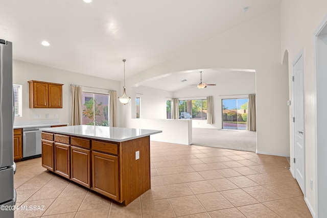 kitchen with a kitchen island, recessed lighting, arched walkways, light countertops, and lofted ceiling