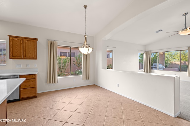 kitchen with light tile patterned floors, brown cabinetry, visible vents, light countertops, and dishwasher