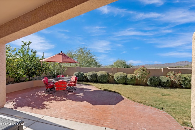 view of patio featuring outdoor dining area and fence