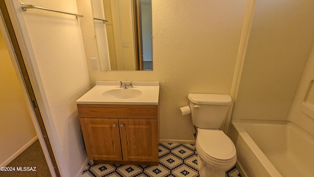 bathroom featuring vanity, toilet, and a washtub