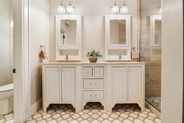 bathroom with tile patterned floors, vanity, and toilet