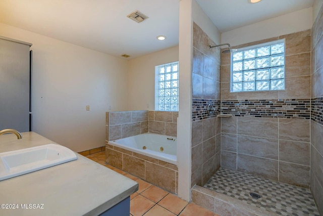 bathroom featuring vanity, tile patterned floors, and shower with separate bathtub