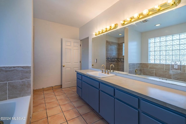 bathroom featuring vanity, tile patterned floors, and a bathtub