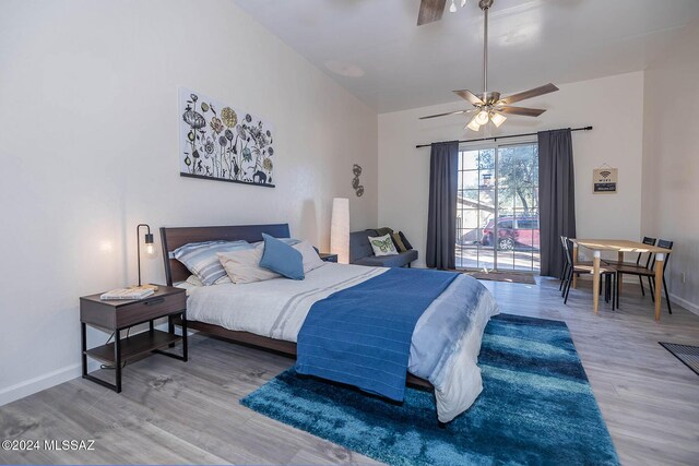 bedroom featuring vaulted ceiling, hardwood / wood-style floors, and ceiling fan