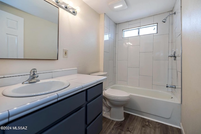 full bathroom with toilet, vanity, bathtub / shower combination, and hardwood / wood-style floors