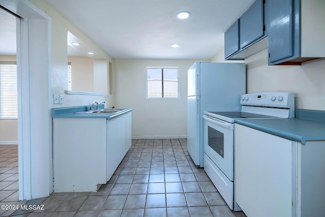 kitchen featuring light tile patterned flooring, white electric range, and sink