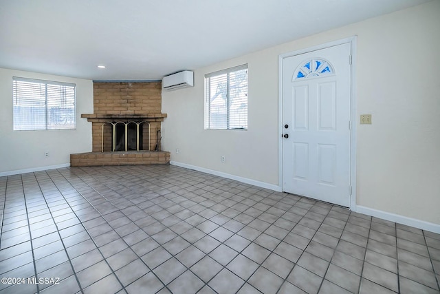 entryway featuring a brick fireplace and an AC wall unit