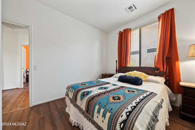 bedroom featuring dark hardwood / wood-style flooring