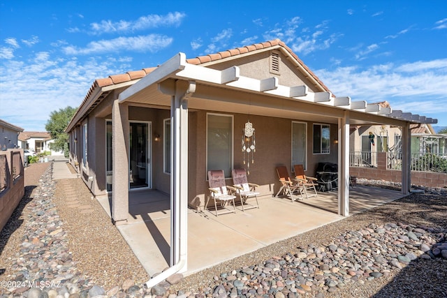 rear view of property featuring a patio area