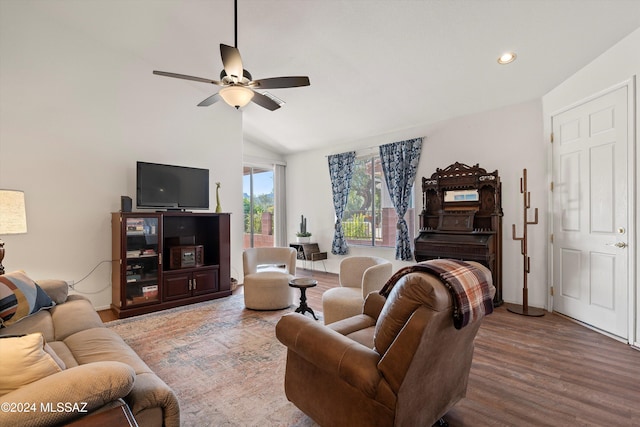 living room with hardwood / wood-style floors, ceiling fan, and lofted ceiling