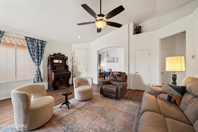 living room with wood-type flooring, vaulted ceiling, and ceiling fan