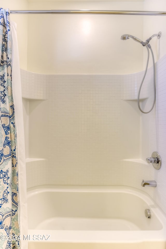 bathroom with shower / bath combo with shower curtain