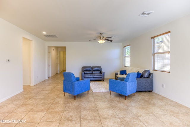 living room featuring ceiling fan and light tile patterned flooring