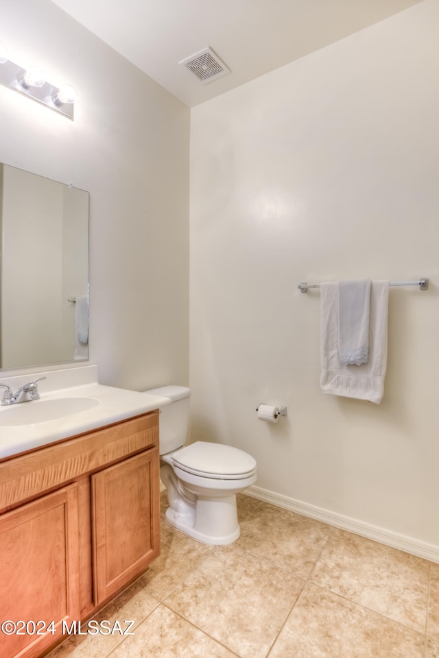 bathroom with tile patterned floors, vanity, and toilet