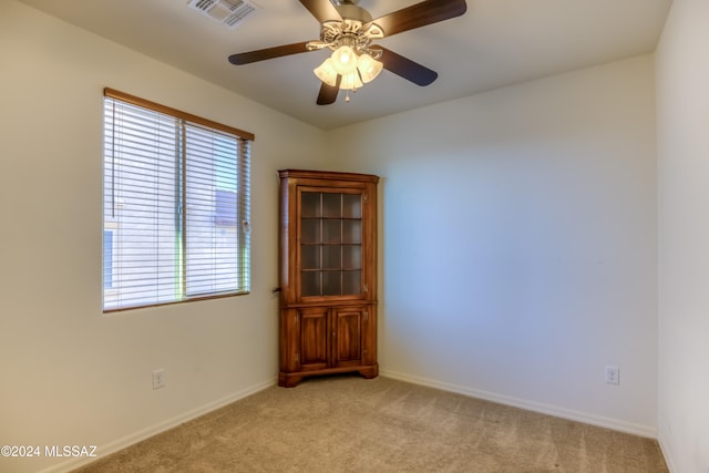 spare room with light carpet and ceiling fan