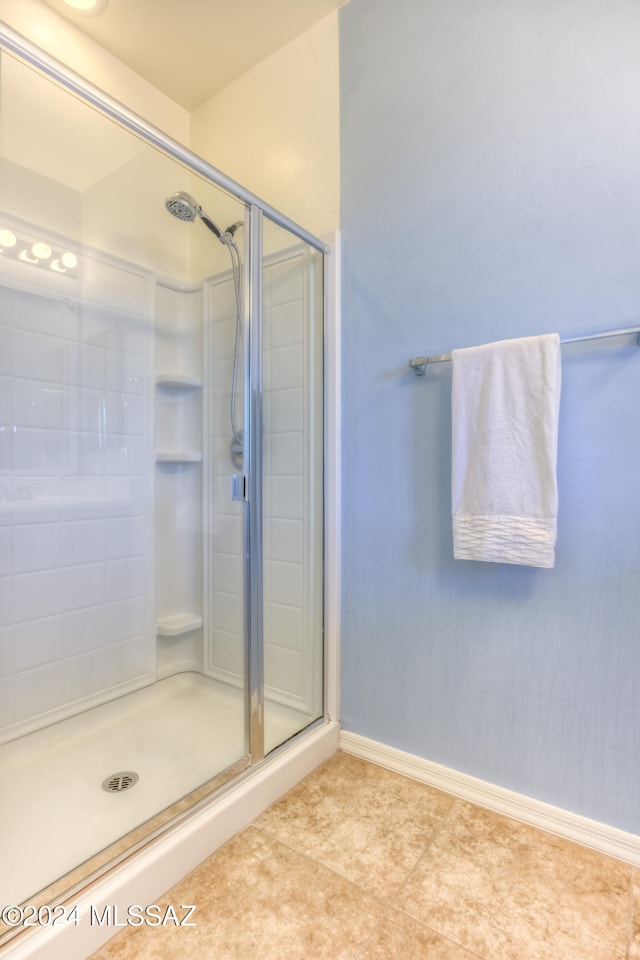 bathroom with tile patterned floors and an enclosed shower