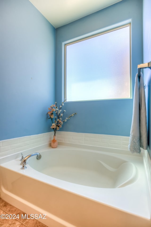 bathroom with a bathing tub and tile patterned floors