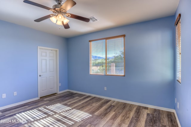 spare room featuring dark hardwood / wood-style floors and ceiling fan