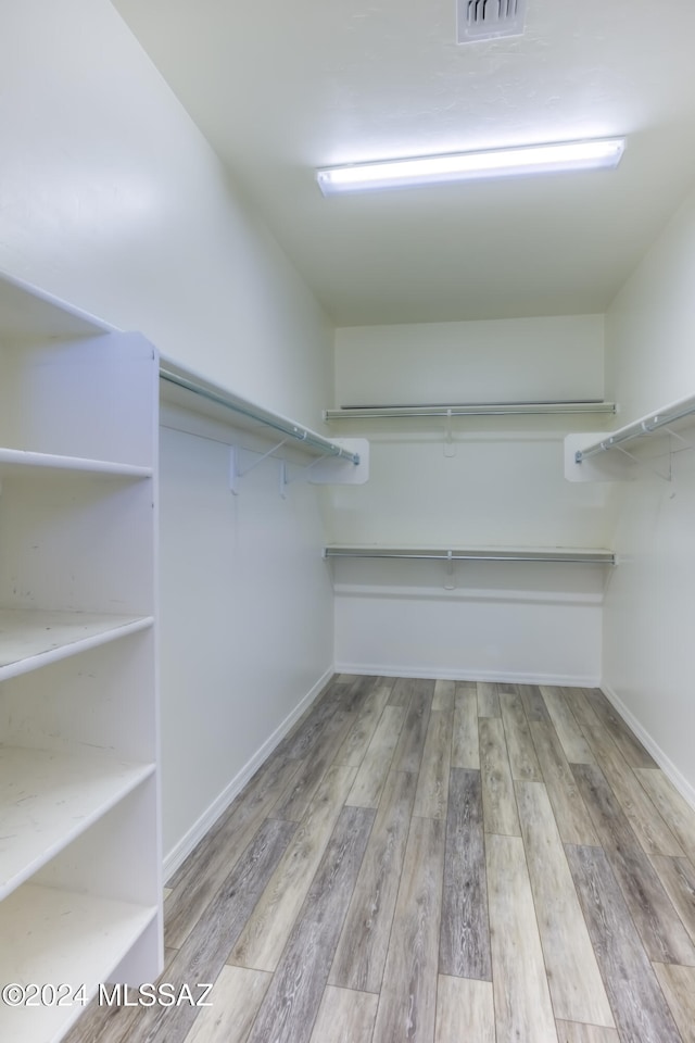 spacious closet featuring light wood-type flooring