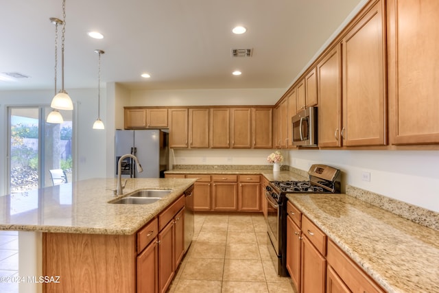 kitchen featuring stainless steel appliances, sink, light tile patterned floors, a center island with sink, and hanging light fixtures