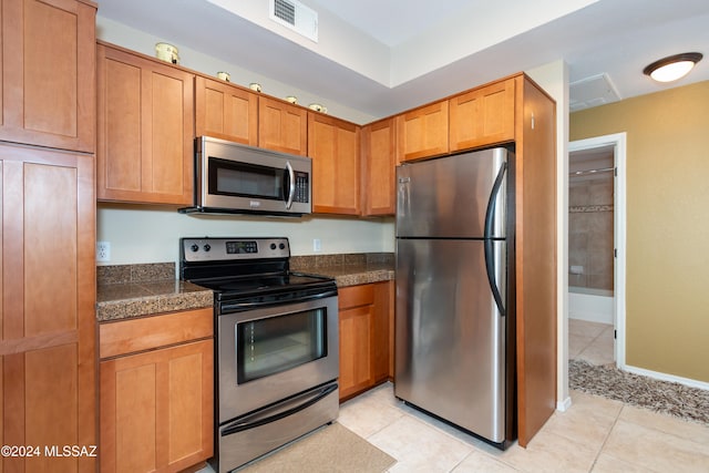 kitchen featuring appliances with stainless steel finishes and light tile patterned floors