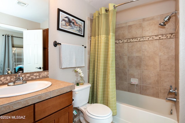 full bathroom featuring toilet, shower / bath combo, and vanity