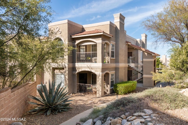 view of front of home featuring a balcony