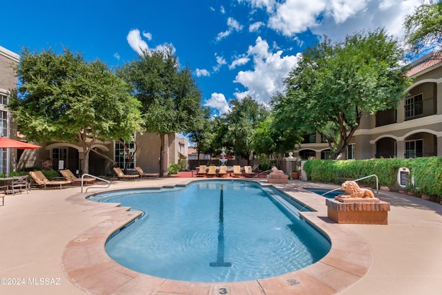 view of swimming pool featuring a patio area