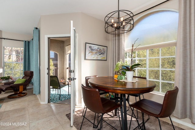 dining room with a chandelier and light tile patterned flooring