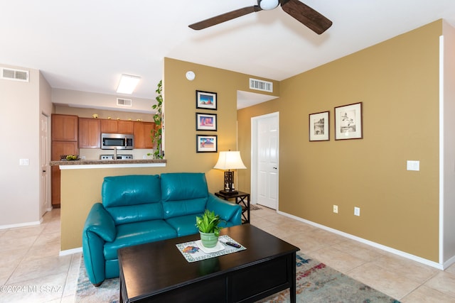 living room featuring light tile patterned floors and ceiling fan