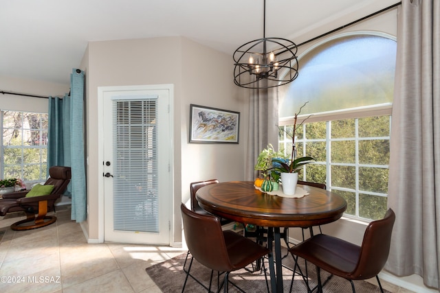 tiled dining room featuring a chandelier