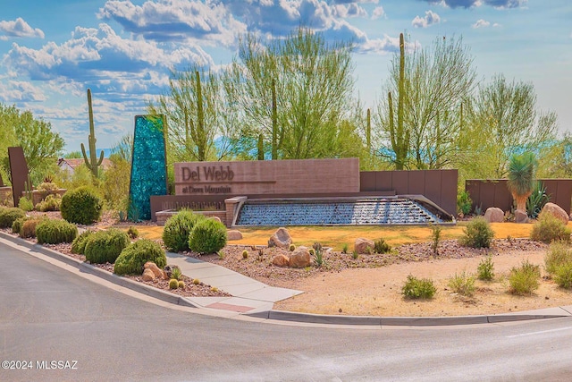 community / neighborhood sign with fence
