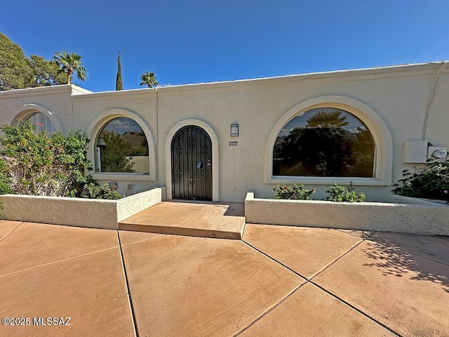 8034 E Shadow Ln, Tucson, AZ 85750 - doorway to property with stucco siding