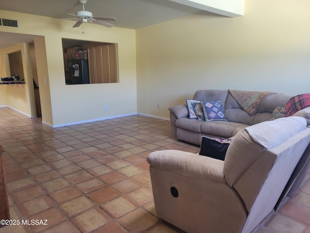 tiled living room featuring ceiling fan