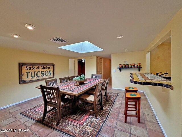8034 E Shadow Ln, Tucson, AZ 85750 - dining room with a skylight, stone tile floors, baseboards, and recessed lighting